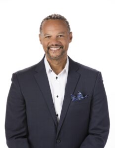 A smiling man in a suitcoat