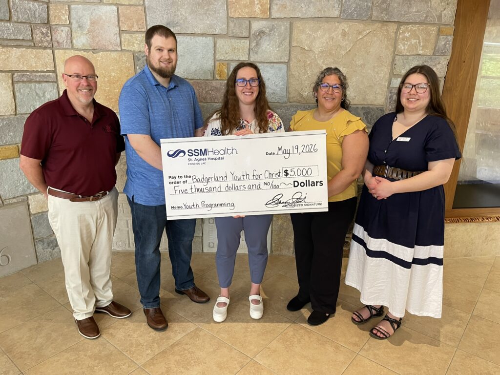 Five people holding a big check