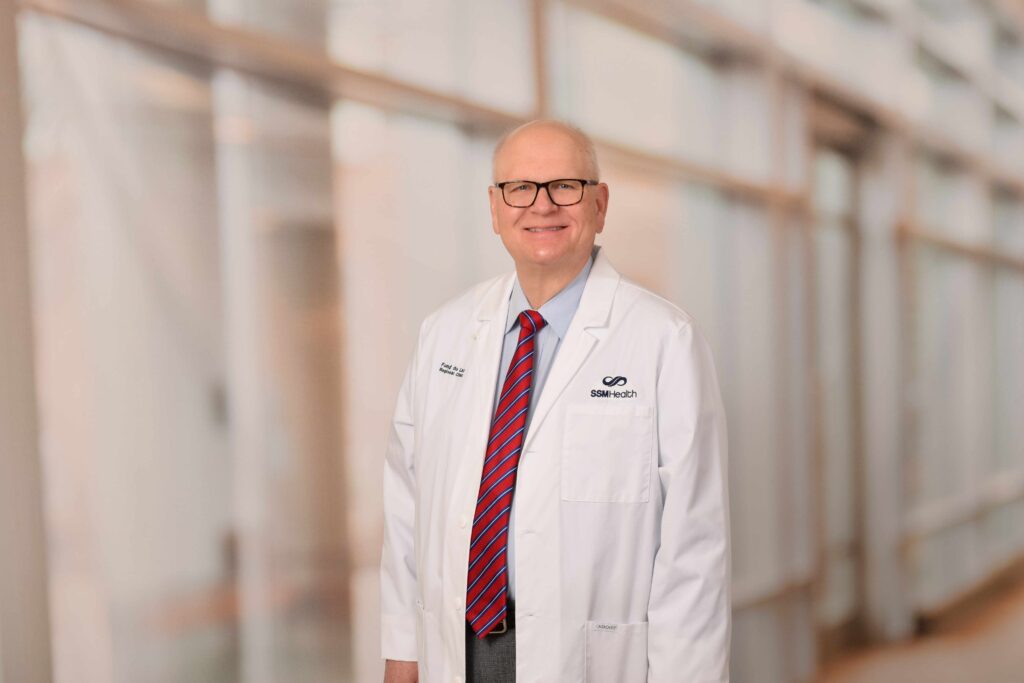 An older male doctor in a hallway