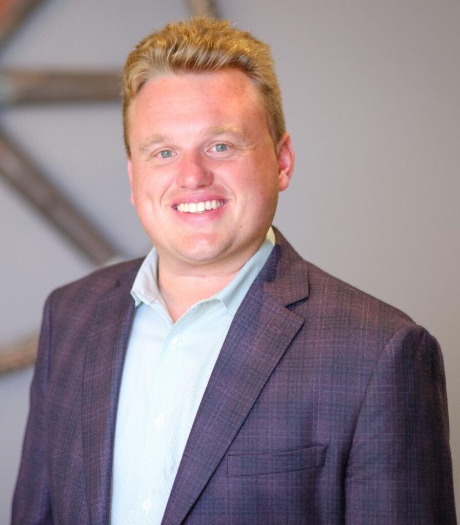A smiling man in a suit coat