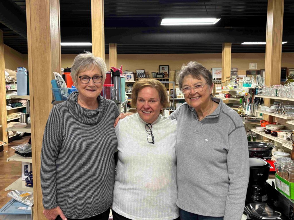 Three women standing in a store