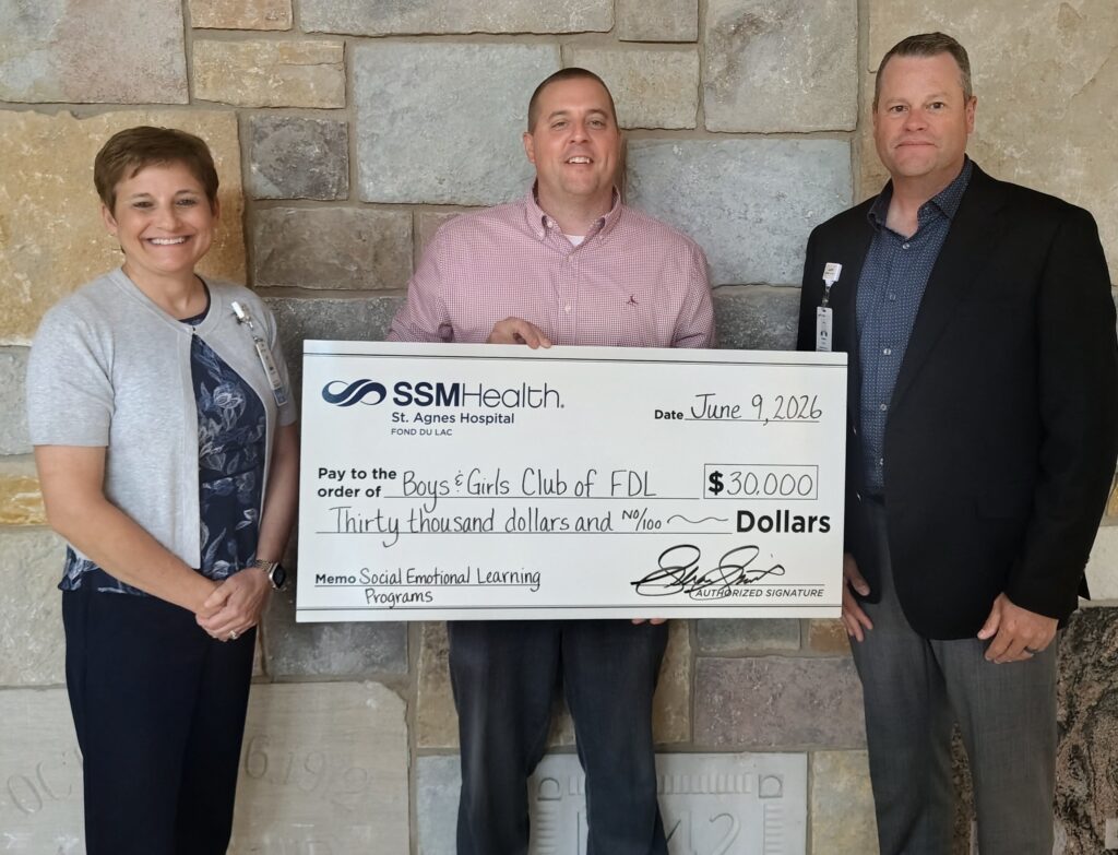 Two men and a woman holding a big check