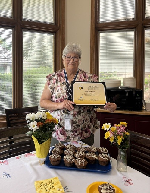 A woman holding a certificate