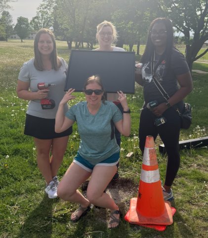 Four women outside with equipment