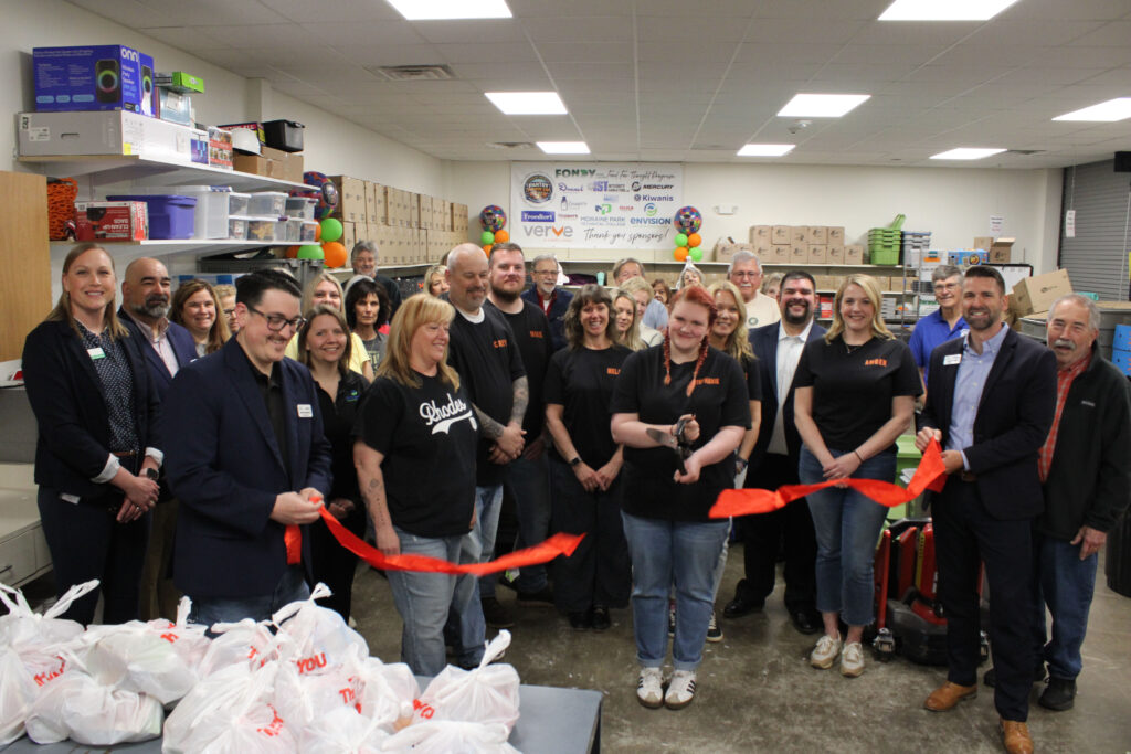 A large group inside for a ribbon cutting