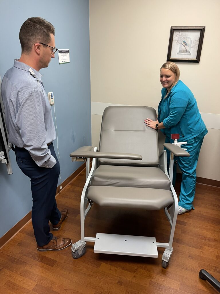 A man and a woman by a patient chair