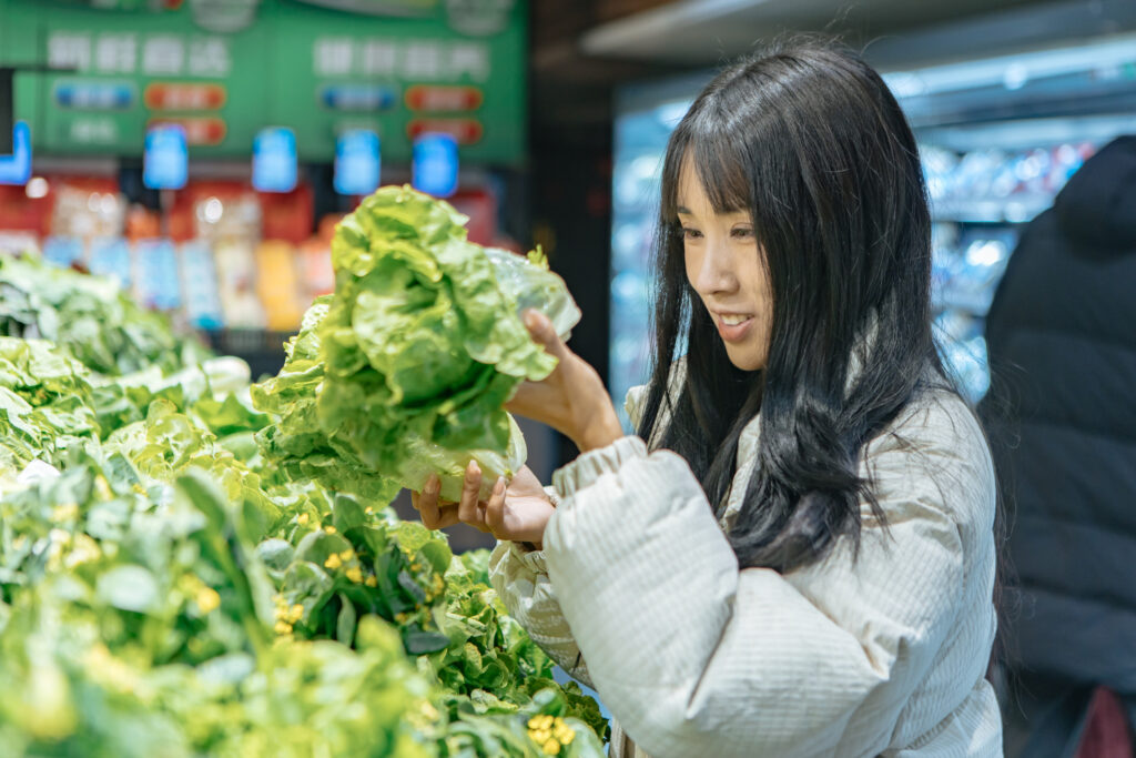A woman buying lettuce