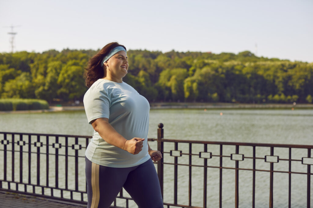 A woman walking by water