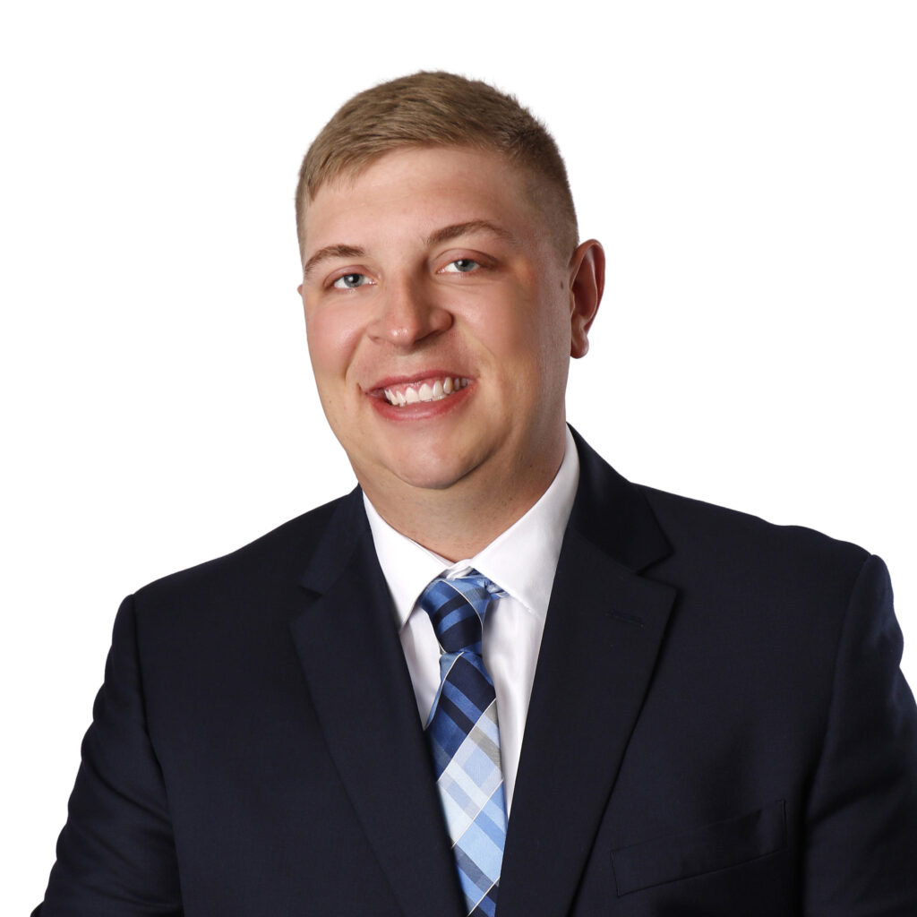 A smiling young man in a suit and tie