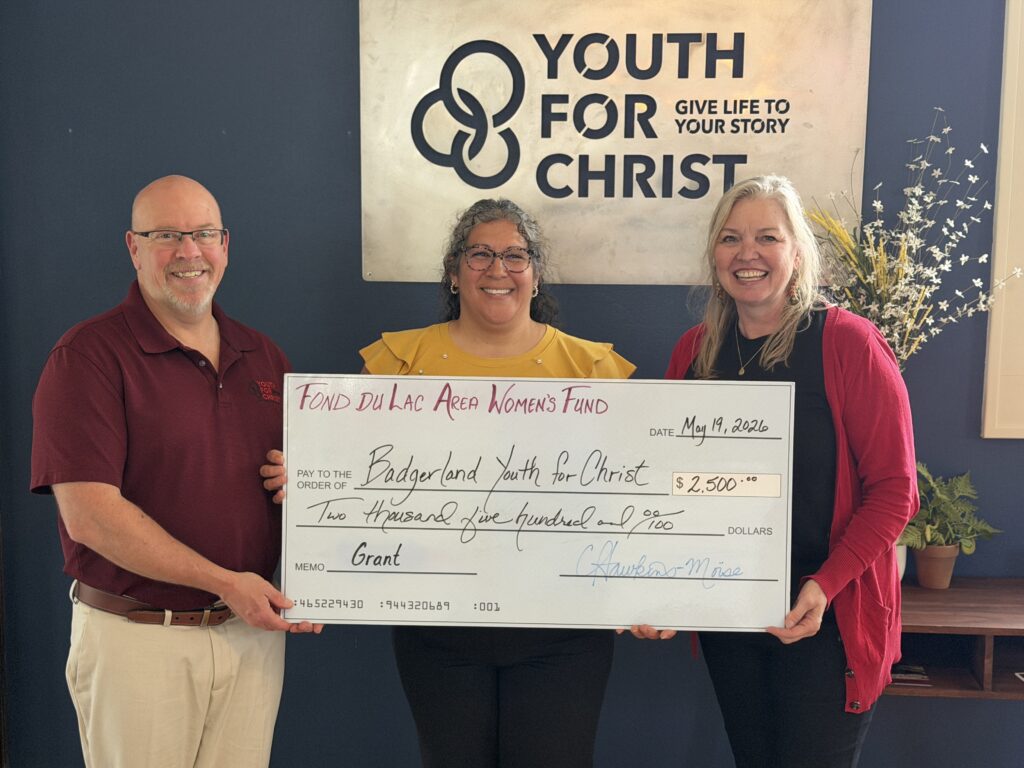 Three people with a big check