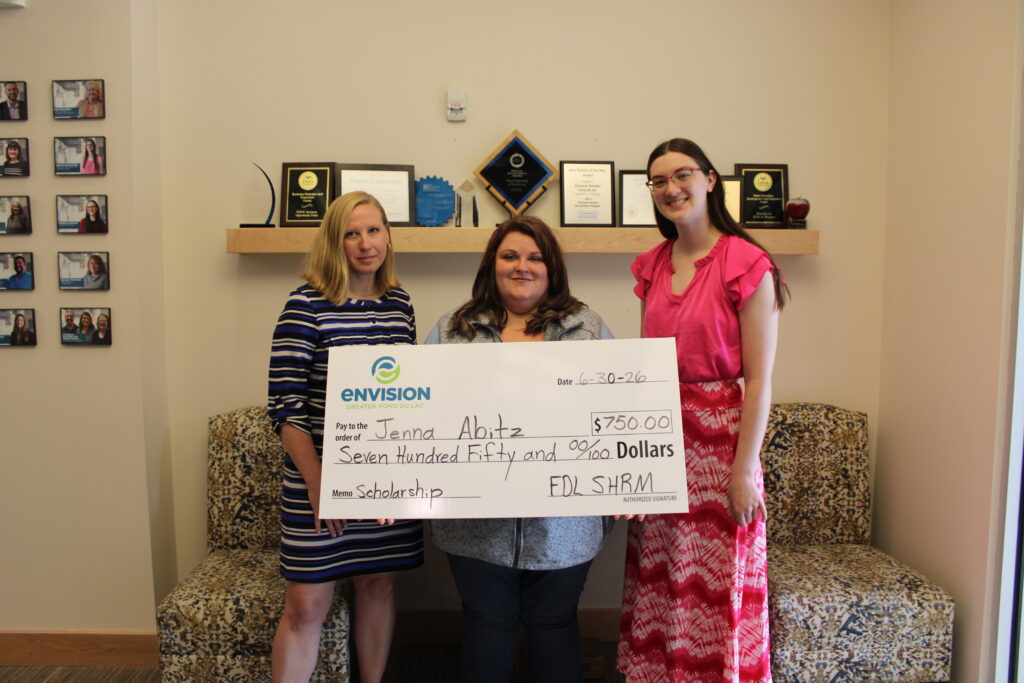 Three women with a big check