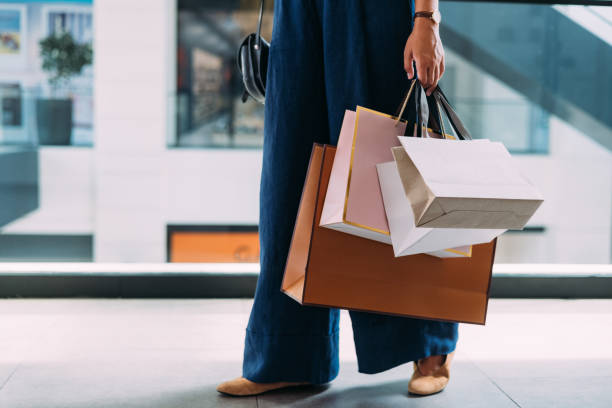 A person shopping holding bags