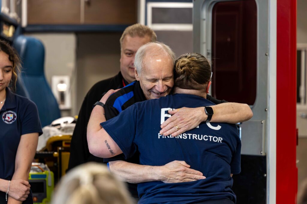 An older man hugging someone
