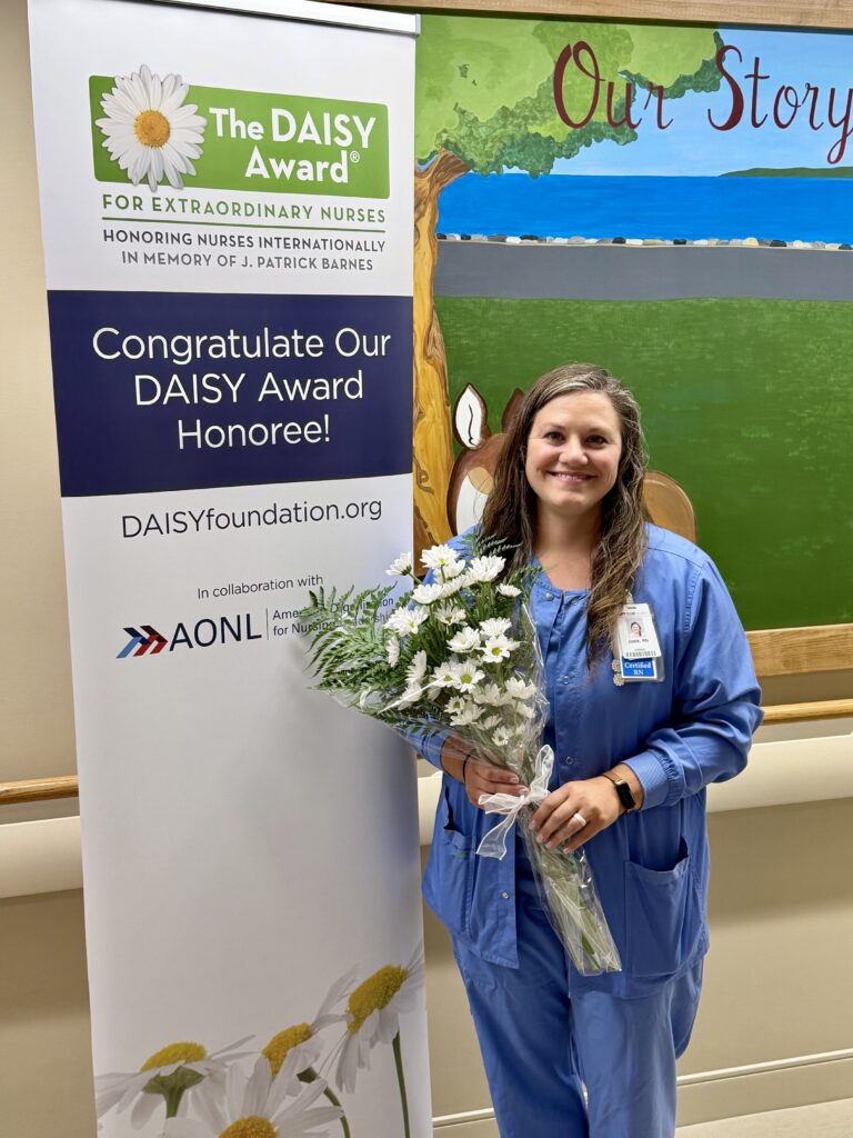Female nurse holding a bunch of flowers