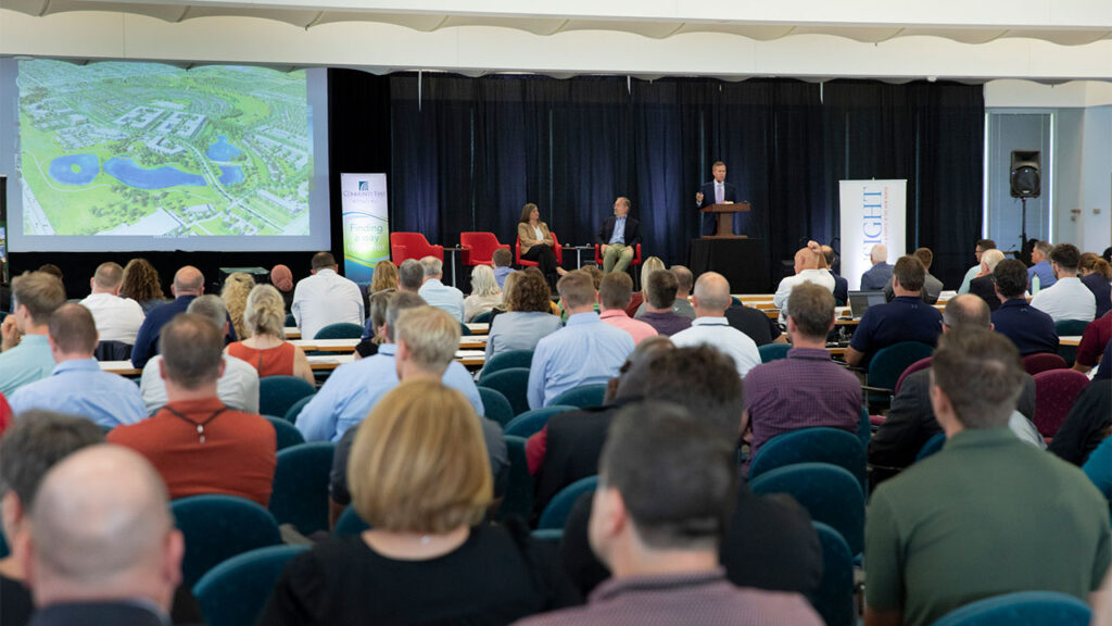 A group of people listening to a presentation