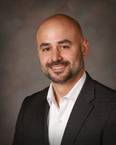 A middle-aged man in a suit coat
