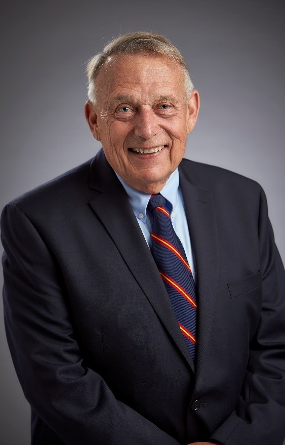 An older man in a suit and tie