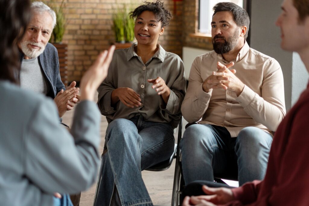 A group of people sitting around talking