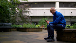 A man sitting on a bench outside