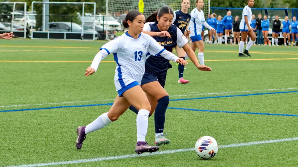 women playing college soccer
