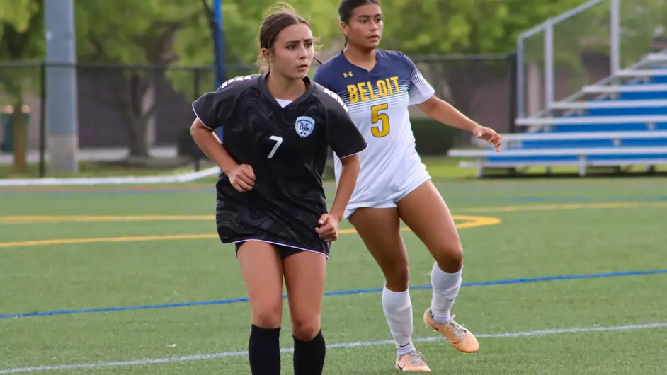 Women playing college soccer