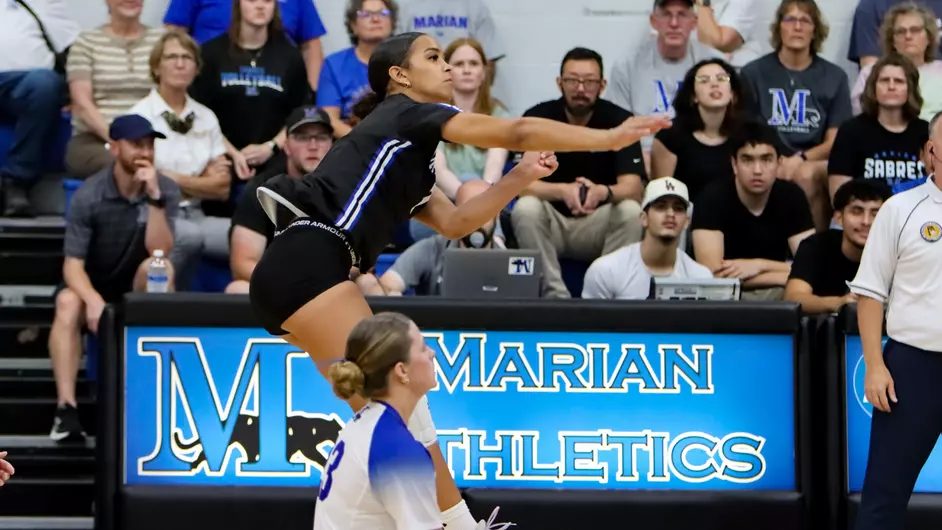 Women playing college volleyball
