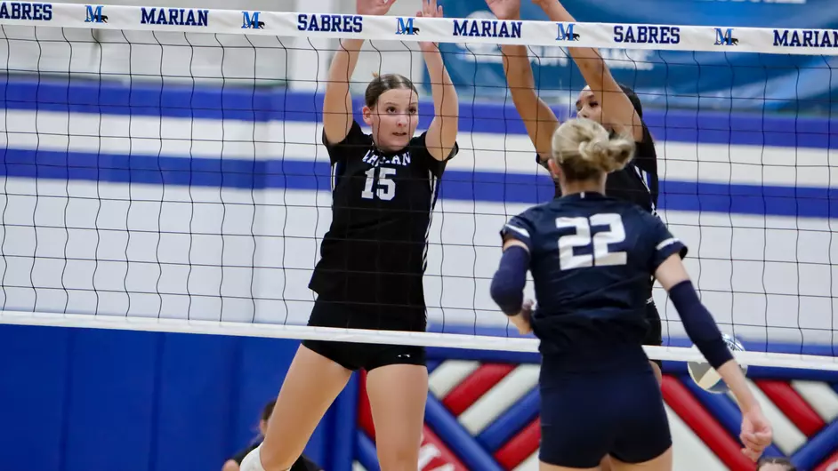 Women playing college volleyball