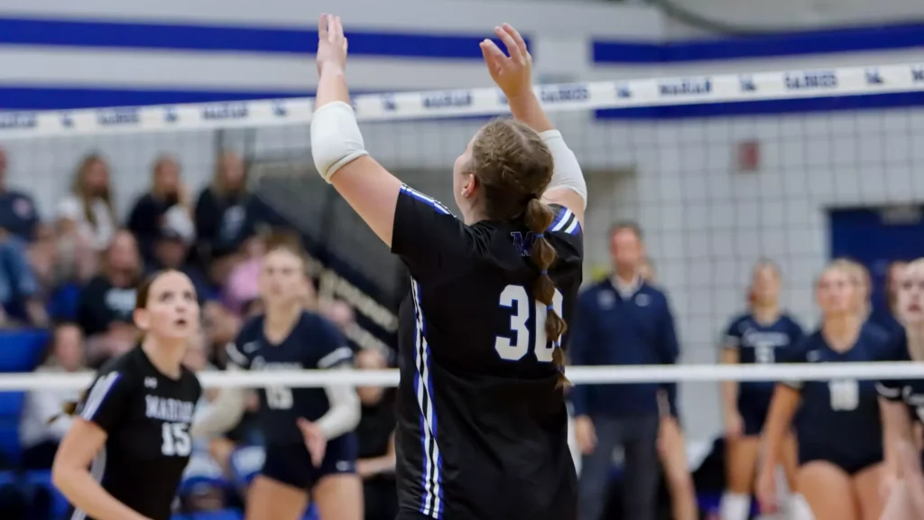 women playing college volleyball