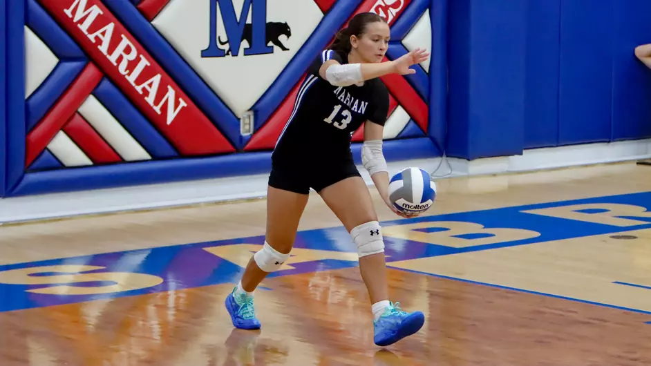 Women playing college volleyball