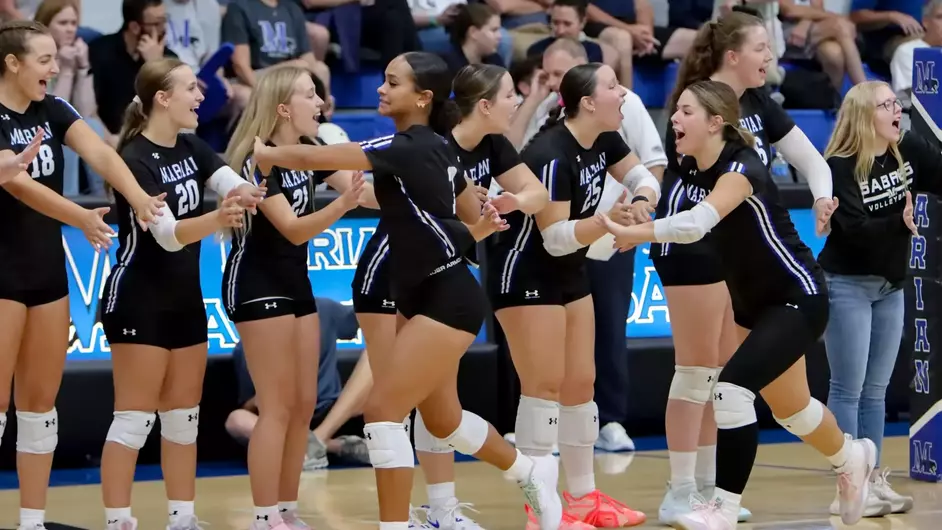 Women playing college volleyball