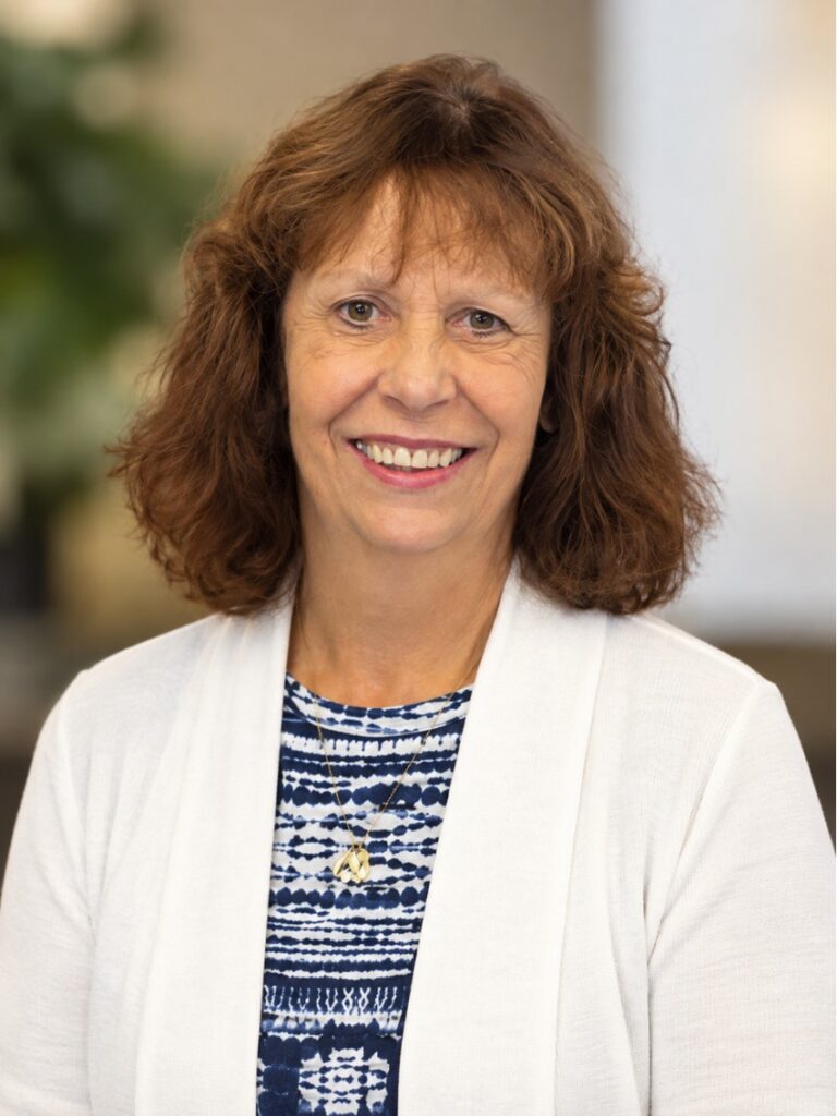 A middle aged woman in a sweater