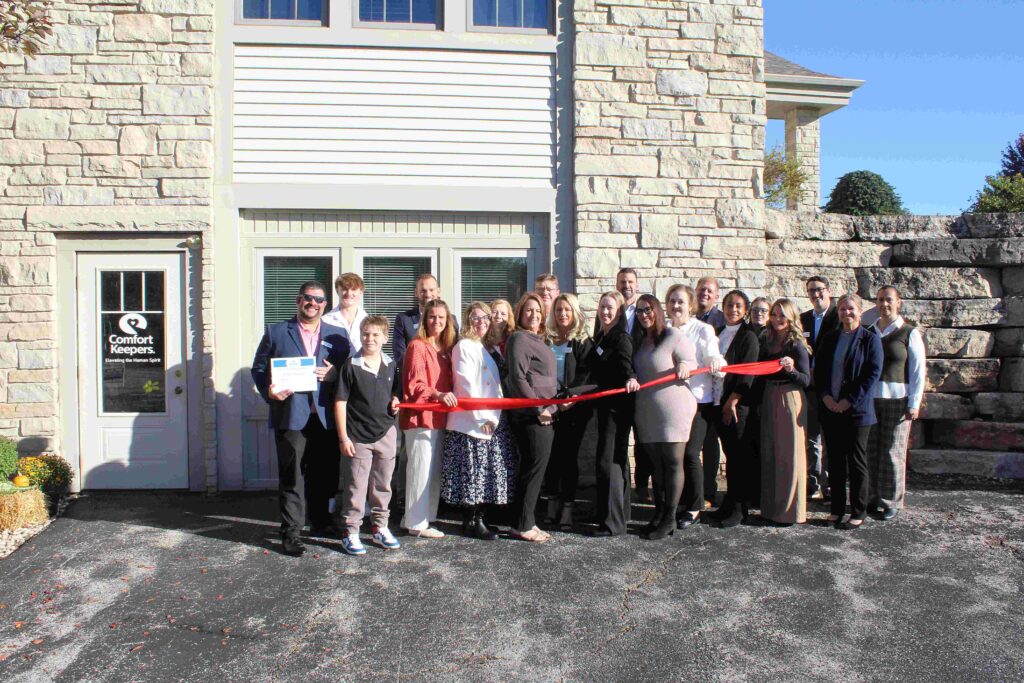 A large group of people outside for a ribbon cutting