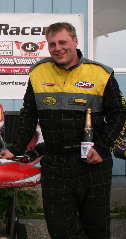 A man standing next to a go-kart