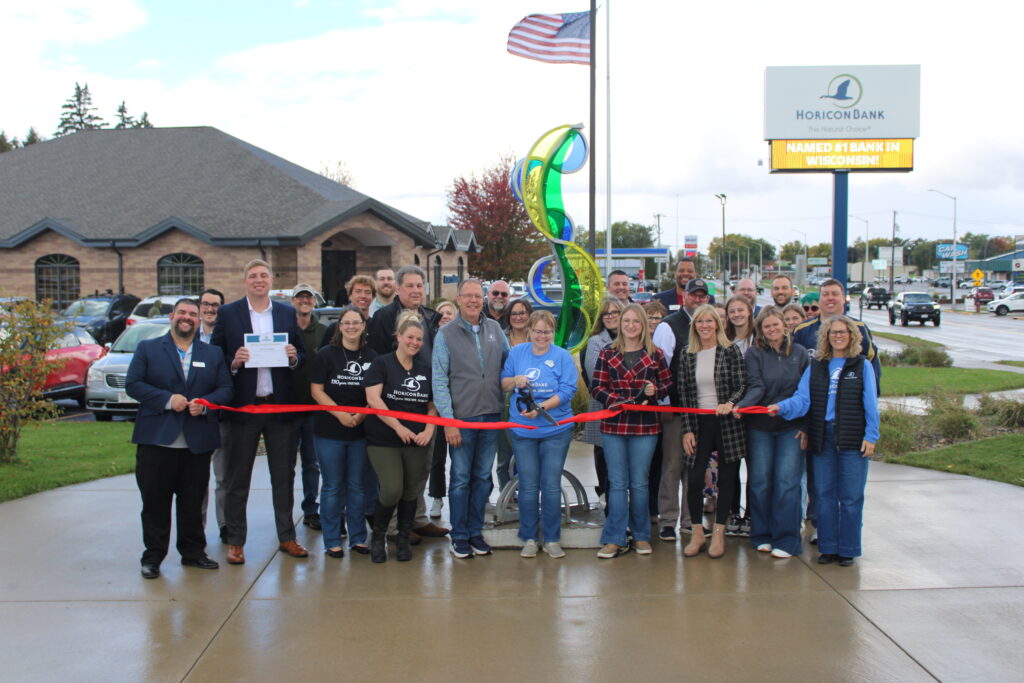 A large group of people outside for a ribbon cutting