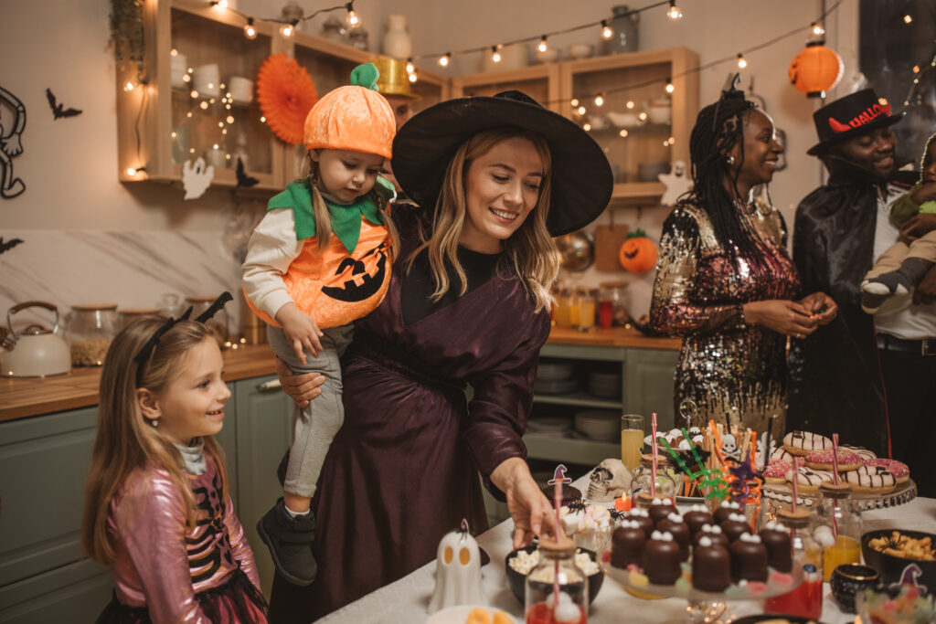 A mother and daughter in costumes in a kitchen