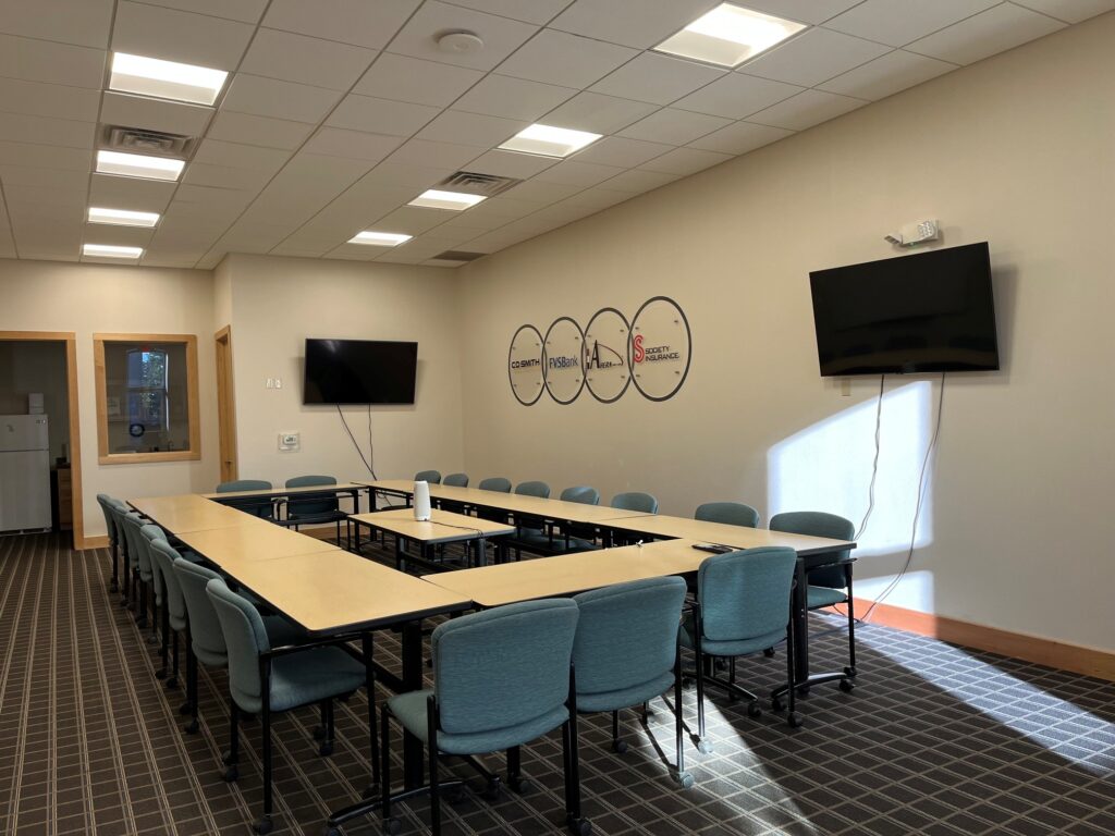 A board room with chairs and tables