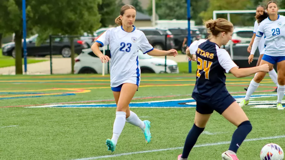Women playing college soccer