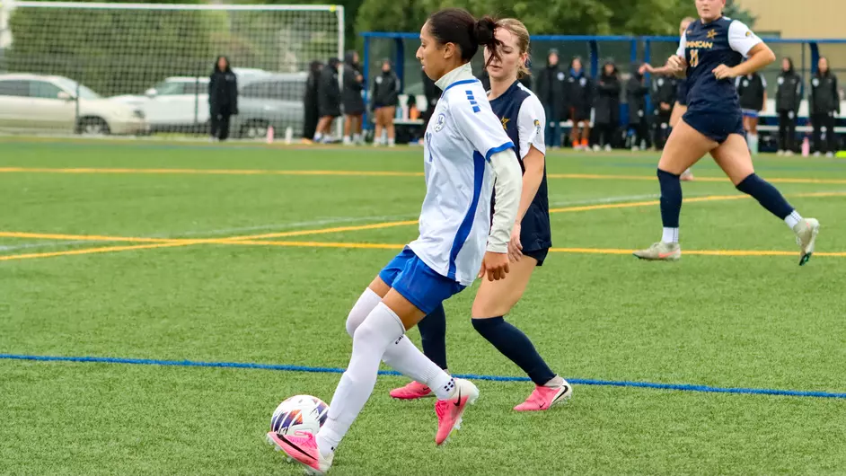 women playing college soccer