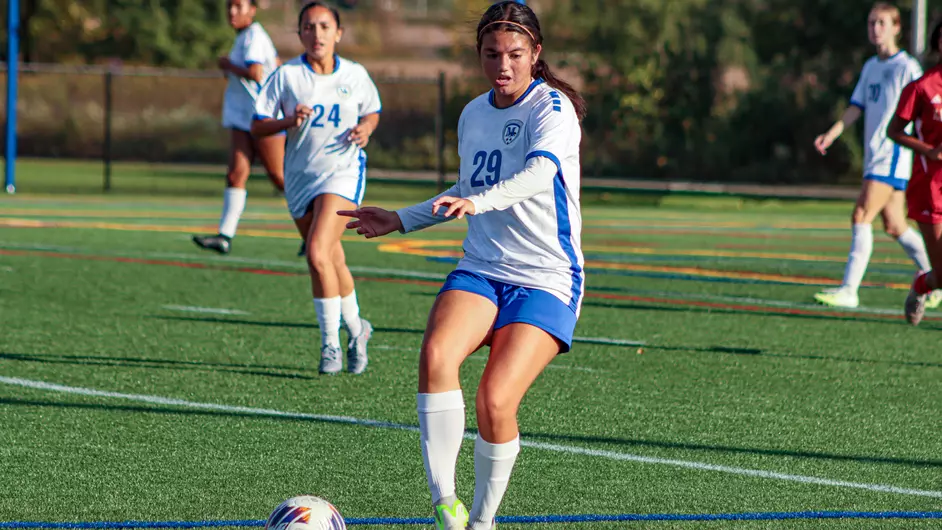 Women playing college soccer