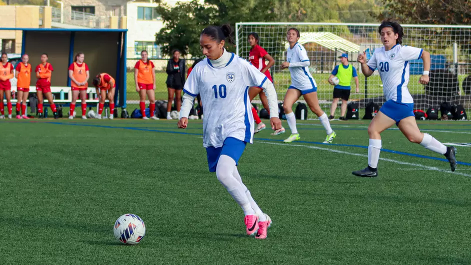Women playing college soccer