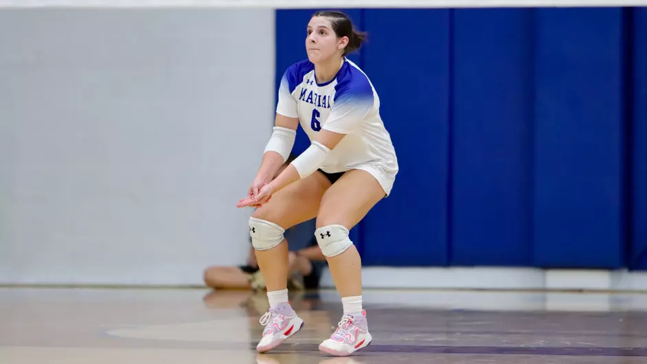 Women playing college volleyball