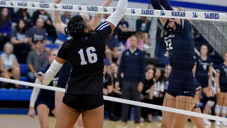 Women playing college volleyball