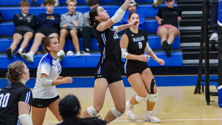 Women playing college volleyball
