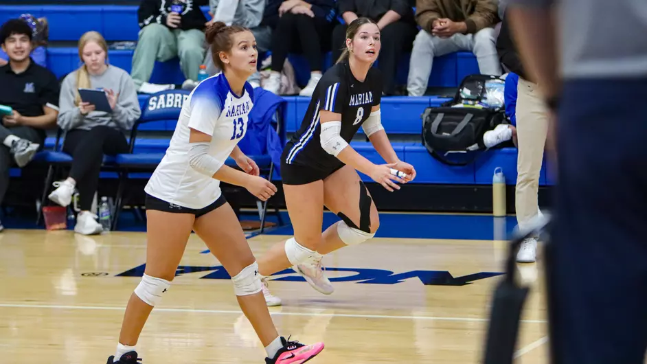 Women playing college volleyball